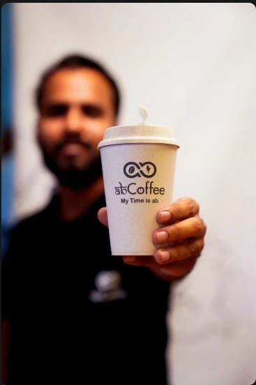 Coffee brand moment held toward the camera