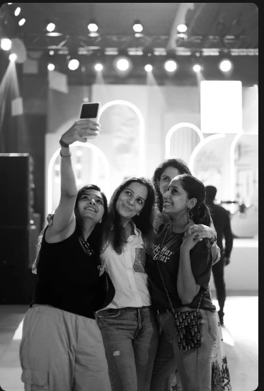 Three friends taking a selfie at an event